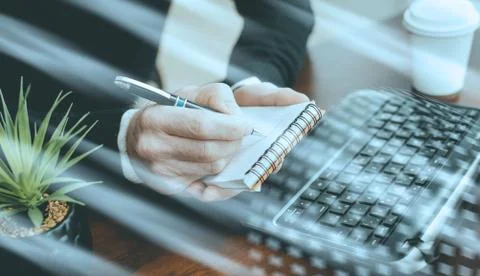 Hands taking notes on notebook; light effect 스톡 사진