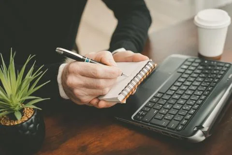 Hands taking notes on notebook 写真素材