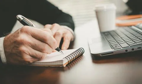 Hands taking notes on notebook 스톡 사진