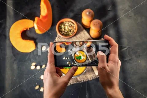 Hands taking photo a homemade pumpkin soup Stock Photos