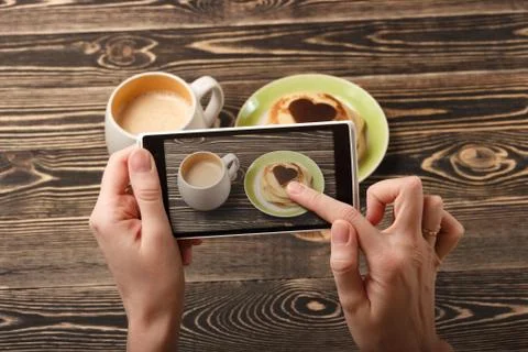 Hands taking photo pancakes with smartphone Stock Photos