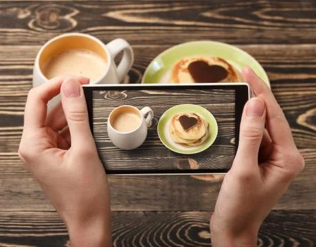 Hands taking photo pancakes with smartphone Stock Photos