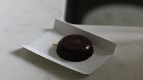Hands taking a piece of chocolate and taking a bite Stock Footage 334969688