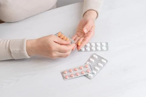 Hands taking pill from blister pack, concept of medication usage and daily .. Stock-Fotos