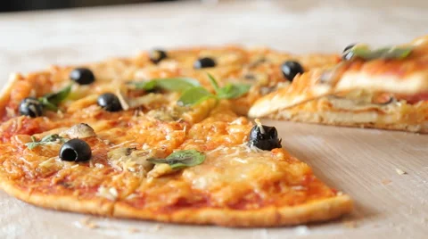 Hands taking pizza cuts from plate on table. Stock Footage 65628521