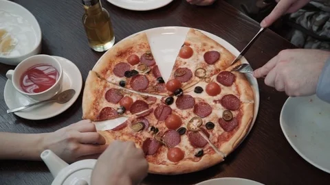 Hands taking pizza cuts Top view, close-up shot. In a cafe, communication and Stock Footage 74806399