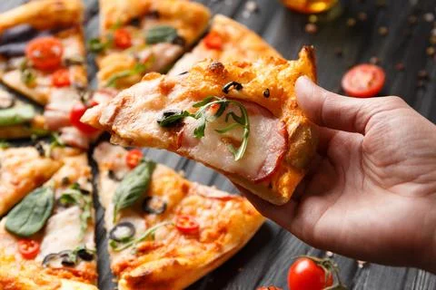 Hands taking pizza slices top view. Stock Photos