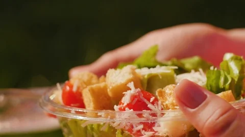 Hands taking plastic box with vegetable salad, takeaway meal. Close up shot. Stock Footage 111579099