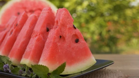 Hands taking red watermelon slices from a plate. Camera slide. Stock Footage 113392139