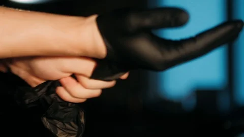 Hands taking on rubber gloves Stock Footage 125458645