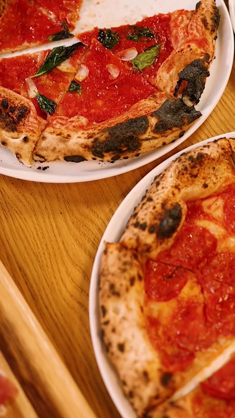 Hands Taking Slices of Fresh Neapolitan Pizza from Restaurant Table 스톡 동영상 338420235