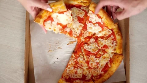 Hands Taking Slices of Pizza Slices of pizza cut in the shop window, ready to be Stock Footage 336586723