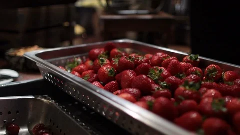 Hands taking strawberries out of large tray Stock Footage 97094150