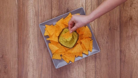 Hands taking tortilla chips from a rotating plate - fast food concept Stock Footage 124233049