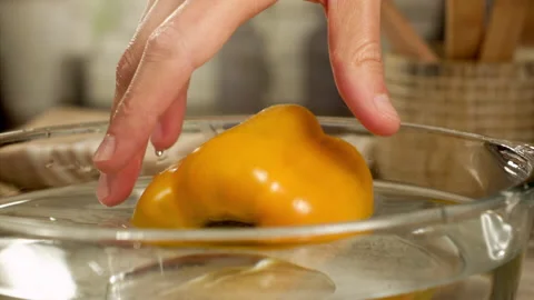 Hands taking yellow bell pepper from water in slow motion Stock Footage 152905108