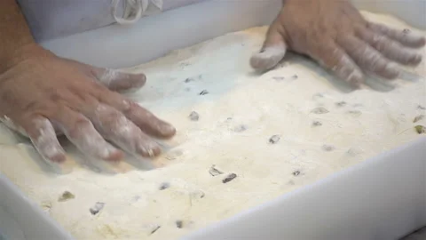 Hands tamp the dough into a baking dish in 4K Video stock 150723158