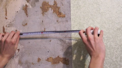 Hands with tape line making a measurement of a wall in construction Stock Footage 67675565