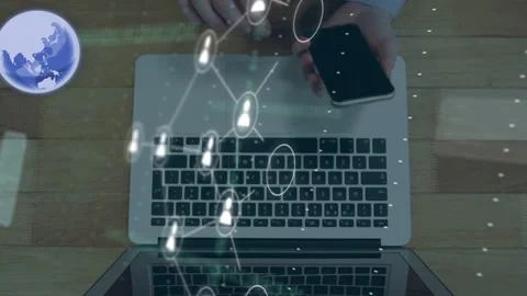 Hands tapping phone, creating network nodes connecting across laptop and showing Stock Footage 335651763