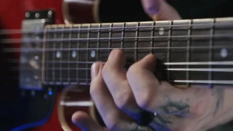 Hands with tattoo on guitar neck Stock Footage 156414155