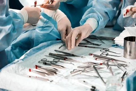 Hands of a team of surgeons close-up in the operating room during the operation Stock Photos