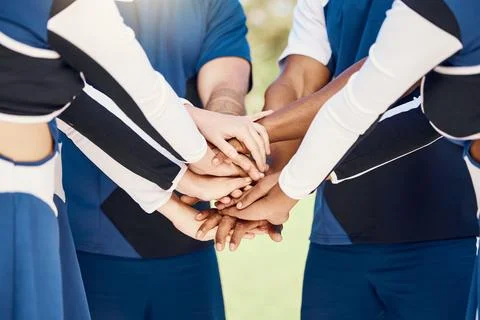 Hands, teamwork and motivation with cheerleaders in a huddle for support during Stock Photos