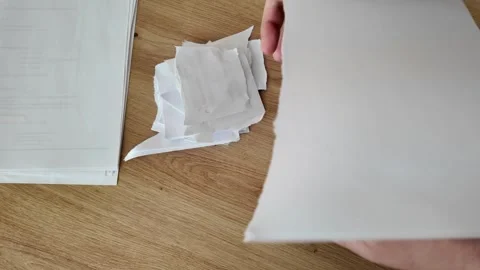Hands tearing A4 paper sheets into four parts and stacking them for disposal Stock Footage 330264583