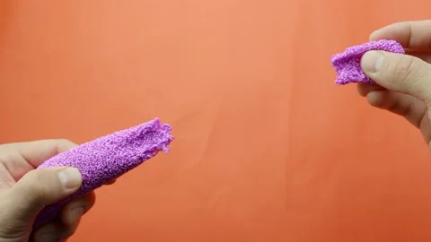 Hands tearing apart lilac floam slime Stock Video Pond5