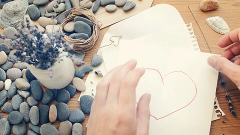 Hands tearing a heart in half. The end of the relationship.  Stock Footage 98139986