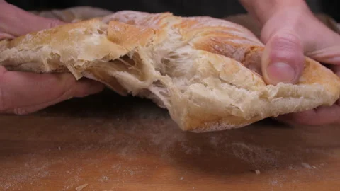 Hands tearing loaf of bread 4k Stock Footage 148318045