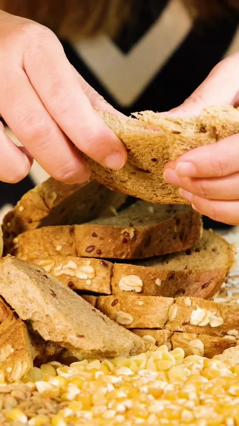 Hands Tearing Whole Wheat Bread in Close-Up Stock Footage 308155304