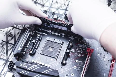 Hands of a technician assembling computer hardware parts new cpu is being mou Stock Photos