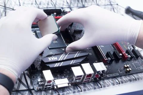 Hands of a technician assembling computer hardware parts new cpu is being mou Stock Photos