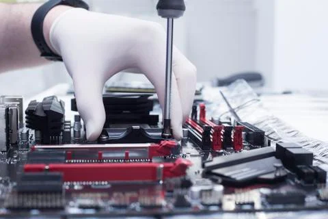 Hands of a technician assembling computer hardware parts new cpu is being mou Stock Photos