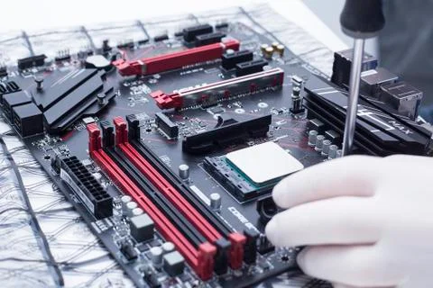 Hands of a technician assembling computer hardware parts new cpu is being mou Stock Photos