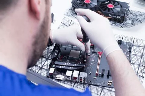 Hands of a technician assembling computer hardware parts new cpu is being mou Stock Photos
