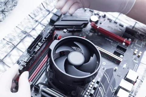 Hands of a technician assembling computer hardware parts new cpu is being mou Stock Photos