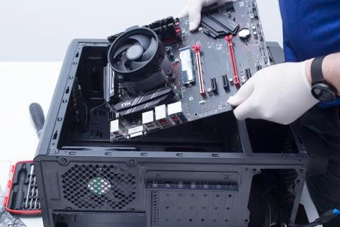 Hands of a technician assembling computer hardware parts new cpu is being mou Stock Photos