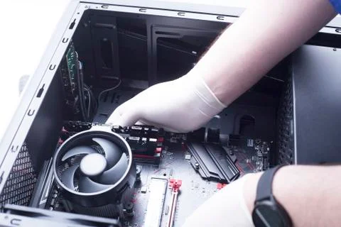 Hands of a technician assembling computer hardware parts new cpu is being mou Stock Photos