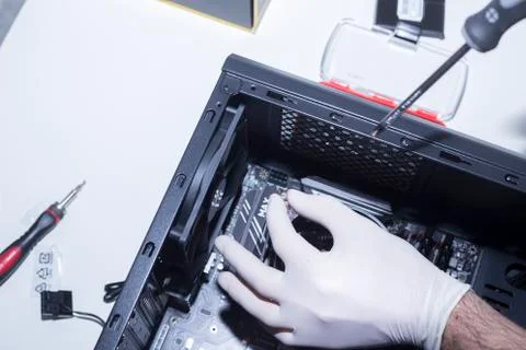 Hands of a technician assembling computer hardware parts new cpu is being mou Stock Photos