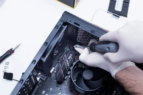 Hands of a technician assembling computer hardware parts new cpu is being mou Stock Photos
