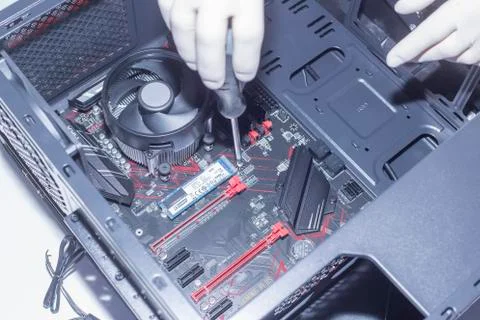 Hands of a technician assembling computer hardware parts new cpu is being mou Stock Photos