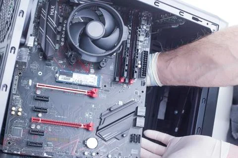 Hands of a technician assembling computer hardware parts new cpu is being mou Stock Photos