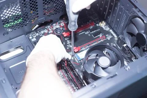 Hands of a technician assembling computer hardware parts new cpu is being mou Stock Photos