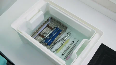Hands of a technician closes the box with dental instruments in alcohol liquid Stock Footage 131483552