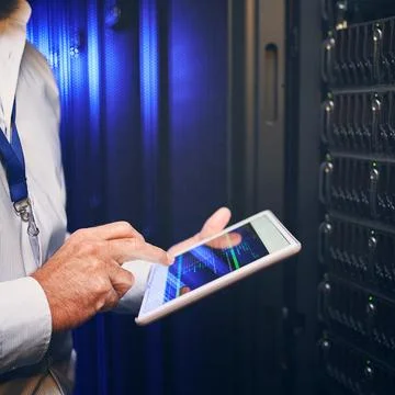 Hands, technician or code on tablet screen in server room for CPU usage, tr.. Stockfoto's