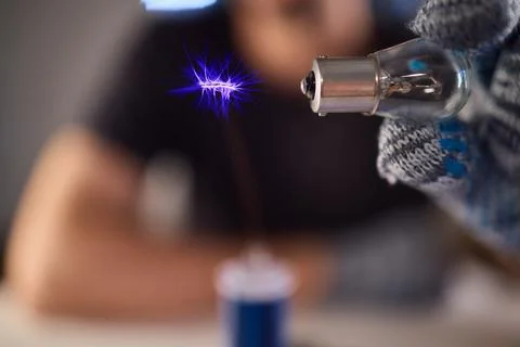 Hands test plasma, Detailed image of electrical discharge testing process Stock Photos