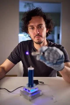 Hands test plasma, Detailed image of electrical discharge testing process Stock Photos
