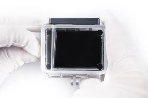 Hands in thick gloves removing protective film from the small screen Stock-Fotos