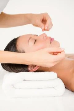 Hands threading beautiful womans face Stock Photos