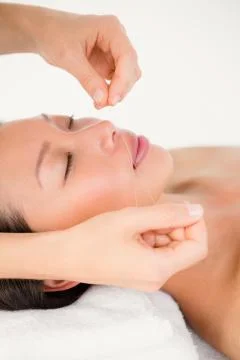Hands threading beautiful womans face Stock Photos